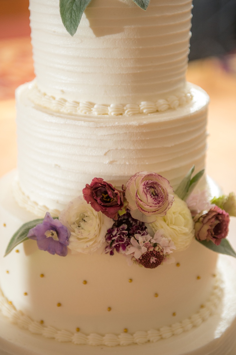 White Wedding Cake with pink and Magenta flowers