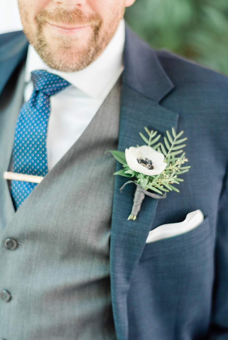 Anemone boutonnière with navy suit