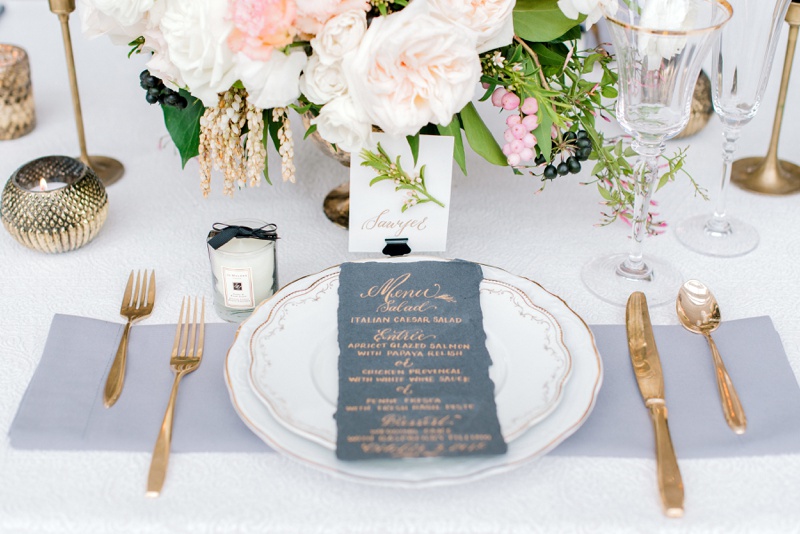white and grey table setting with vintage china and gold flatware