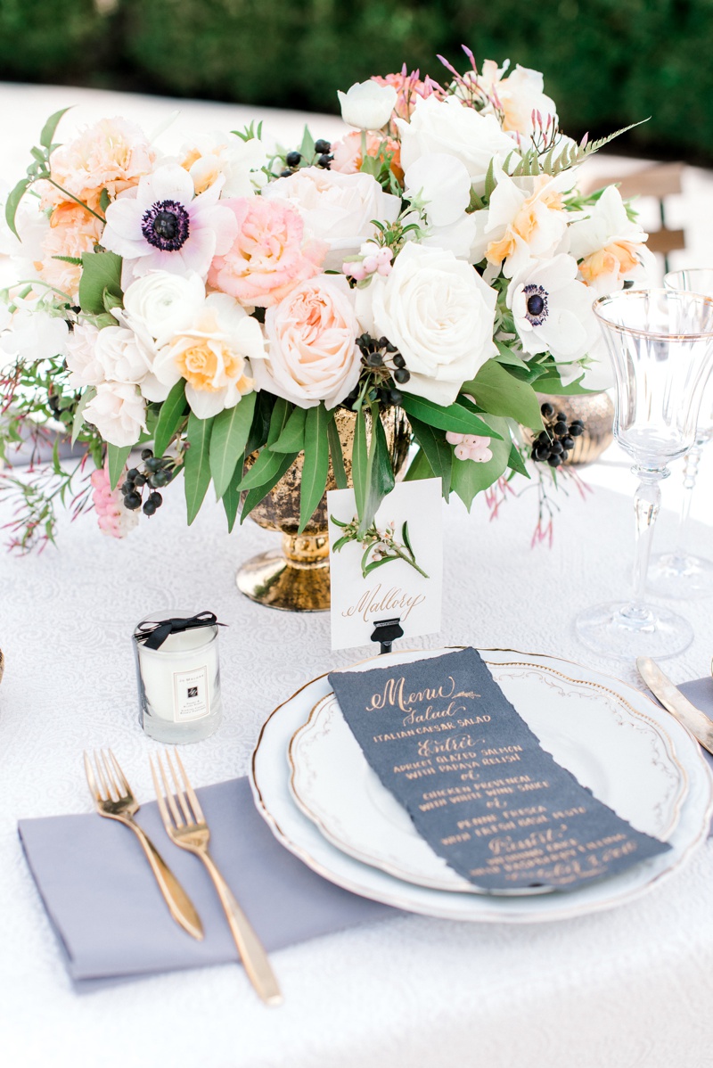 Outdoor wedding reception centerpiece with blush and peach flowers