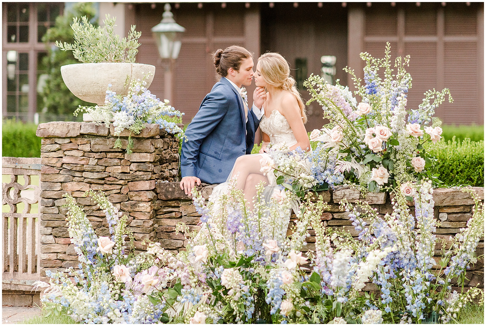 RiverOaks Charleston Bride and Groom sitting on ledge with flowers