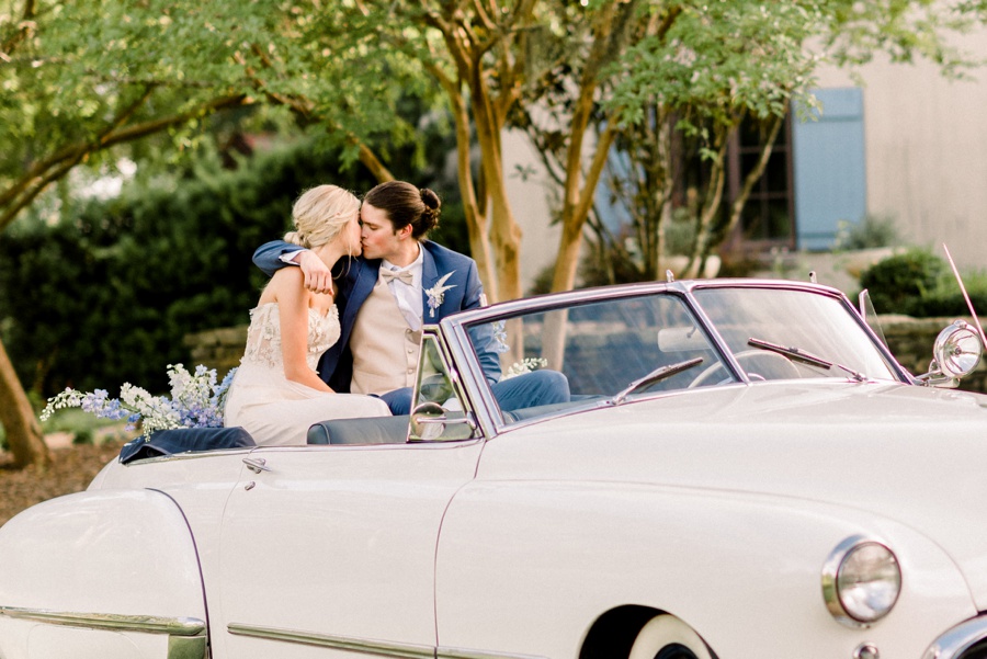 RiverOaks Charleston Bride and Groom kissing on back of vintage white car