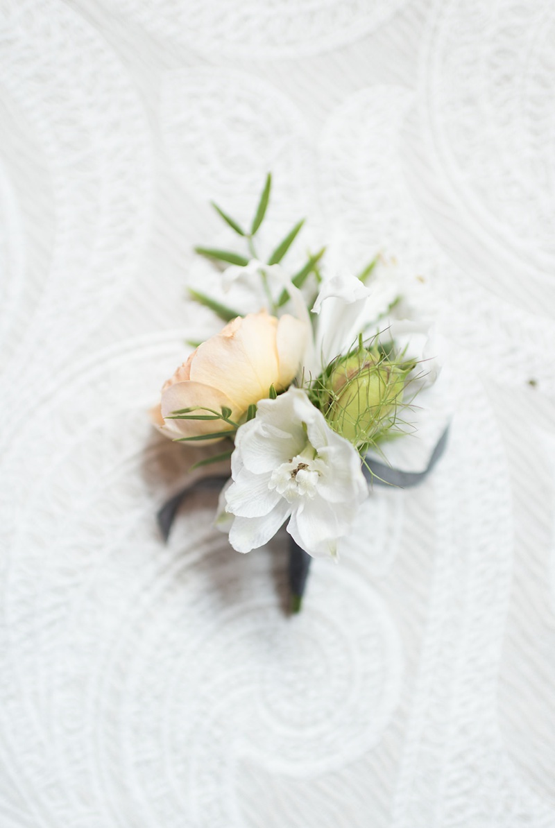 Light Peach boutonnière with charcoal ribbon