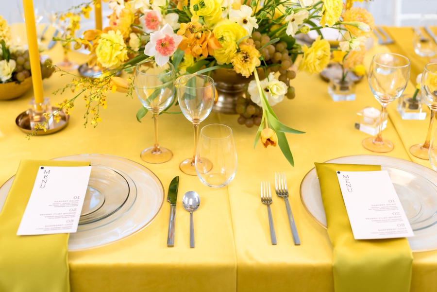 Yellow flowers with yellow linen and satin napkins
